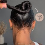 Femme avec un chignon sleek parfait, coiffure lisse et élégante.